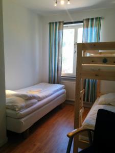 a bedroom with two bunk beds and a window at Virserum Hostel in Virserum