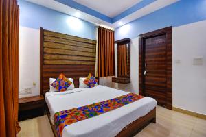 a bedroom with a large bed in a room at FabHotel Ocean View Apartment, Dabolim in Old Goa