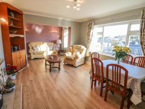 a living room with a table and a couch at Lavender Cottage in Castletownbere