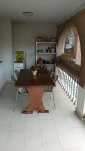 a table and chairs in a room with a staircase at Apartments Dujlovic in Privlaka