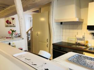 a kitchen with a sink and a counter top at La petite Normande en ville in Louviers