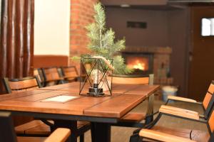 a wooden table with a christmas tree on top of it at Hotel Dąbrowiak in Dąbrowa Górnicza
