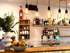 a bar with a bowl of fruit on a counter at Hotel Marie in Skagen