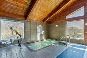 a hot tub in a room with a wooden ceiling at Comfort Inn & Suites Jackson - West Bend in Jackson