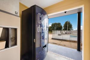 a sliding glass door with a view of a gate at Econo Lodge Russellville in Russellville