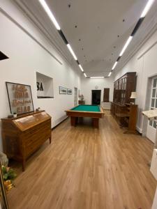 a gallery with a pool table in a room at Palazzo Carmine a due passi dall'Acquario in Genova