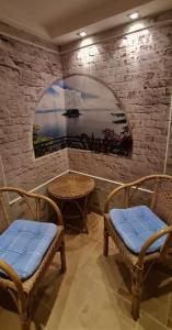 a room with two chairs and a table and a window at Hotel Prox in Arnstadt