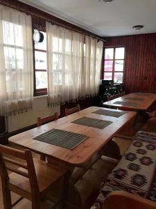 a dining room with tables and chairs and windows at Cabana Fundata in Fundata