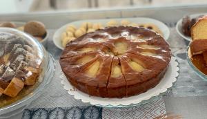 a chocolate cake sitting on a table with other pastries at Hotel Tritone Rimini in Rimini