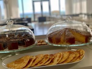 two plates of different types of desserts and cookies at Hotel Tritone Rimini in Rimini