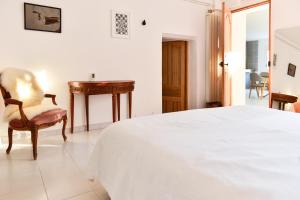 Cama ou camas em um quarto em L’appartement - Jardin Secret