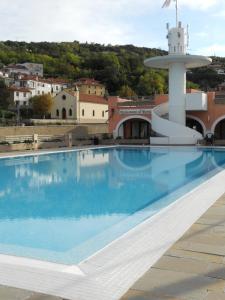 a swimming pool on the roof of a building at Hotel San Rocco in Muggia