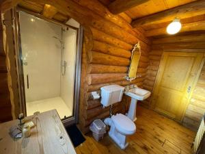 Kylpyhuone majoituspaikassa Woodpecker Log Cabin with hot tub, pizza oven bbq entertainment area, lakeside with private fishing peg situated at Tattershall Lakes