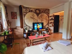 a living room with a tv and a table at Impeccable apartment with view in Dolna Matka in Skopje