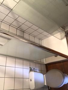 eine Toilette in einem Badezimmer mit einer Lampe darüber in der Unterkunft Accostage Vieux-Port - Appartements & Parking in La Ciotat + 65 Fotos