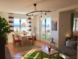 a living room with a table and a couch at Apartment Panoramablick mit Infrarotkabine auf der großen Terrasse und traumhaften Ausblick in Oberschützen