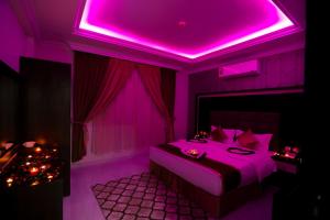 توبتيل للأجنحة الفندقية في الدمام: غرفة أرجوانية مع سرير بسقف أرجواني