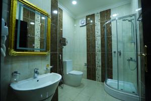 a bathroom with a sink and a toilet and a shower at جراند سيزون للشقق المخدومة in Dammam +45 photos