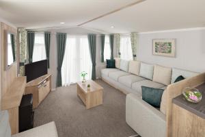 a living room with a couch and a tv at Llanrhidian Holiday Park in Llanmorlais