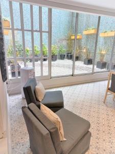 a living room with a couch and a large window at Hotel América in Mar del Plata