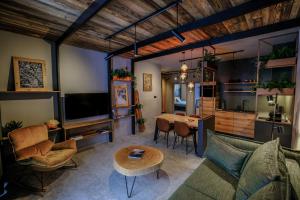a living room with a couch and a table at Apartamenty Riders Lodge Szczyrk Olimpijska in Szczyrk