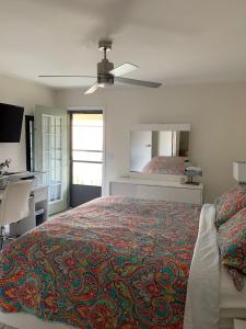 a bedroom with a large bed and a mirror at The Nest Egg in Panama City Beach