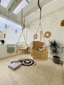 a living room with swings and a rug at Boho-Chic one bedroom flat in Engomi in İncirli