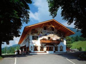 a large white building with a wooden roof at Zum Schweizerbartl in Garmisch-Partenkirchen