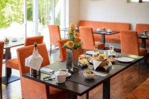 a dining room with a table with food on it at Aparthotel Christine in Bad Füssing