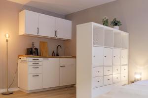 Kuchyň nebo kuchyňský kout v ubytování homie stay Julius Apartments - Iphofen
