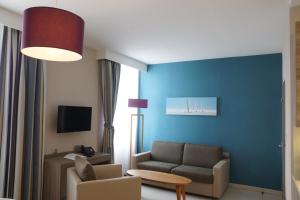 a living room with a couch and a chair at Villa des Thermes in Saint Malo