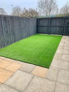 a backyard with a fence and green grass at Amazon View in Bowburn