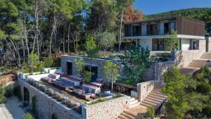 an aerial view of a house with a stone wall at Maslina Resort in Stari Grad