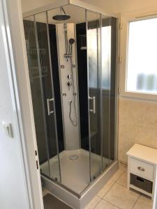 a shower with glass doors in a bathroom at APPARTEMENT INDÉPENDANT 80M² DANS VILLA in Saint-Georges-de-Didonne