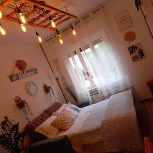 a bedroom with a bed and a clock on the wall at Casa Fiorita 22 Porto Ceresio in Porto Ceresio