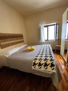 a bedroom with a large bed with two yellow pillows on it at Rifugio Giuliano Marini in Piano Battaglia