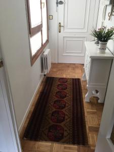 a hallway with a rug on the floor next to a door at Saldaña. Apartamento in Saldaña