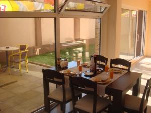 a dining room with a table and chairs and a window at Ivatea Family Hotel in Ravda