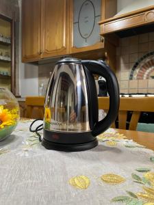 a tea kettle sitting on a table in a kitchen at APPARTAMENTO AFRODITE in Tessennano