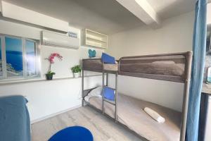 a small room with two bunk beds in it at Le Vrai Cabanon de la Plage Clim-Wifi-Netflix in Marseille