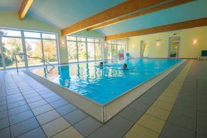 una grande piscina con persone in acqua di Hotel zum Hirschen a Lam