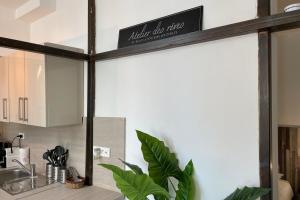 a kitchen with a sink and a shelf with a sign at Atelier des rêvesVieuxPortProche PlagesLaCiotat in La Ciotat