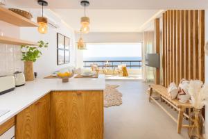 a kitchen with a view of the ocean at Sesimbra Ocean Panorama Apartment in Sesimbra