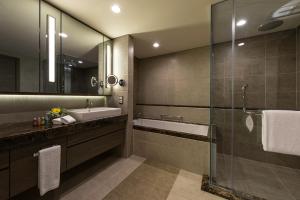 a bathroom with a sink, toilet and bathtub at Ascott Sentral Kuala Lumpur in Kuala Lumpur