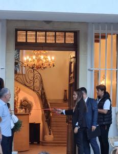 a group of people standing in front of a house at DOMAINE DE LA NERTHE- HOTEL PROVENCE MEDITERRANEE in Gignac-la-Nerthe