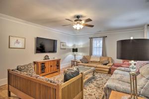 a living room with a couch and a tv at Traditional Southern House with Front Porch! in Anderson