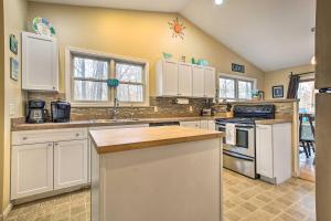 a large kitchen with white cabinets and appliances at Lake Michigan Gem Less Than Half-Mi to Private Beach! in Mears