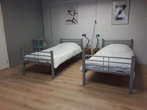 Ліжко або ліжка в номері Residentie De Hoek