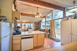 a kitchen with a refrigerator and a stove top oven at Cozy Speculator Cottage about 2 Miles to Ski Resort! in Lake Pleasant
