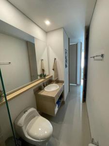 a bathroom with a toilet and a sink and a mirror at Reserva del Mar, Hermoso lugar de Descanso en Santa Marta in Gaira
